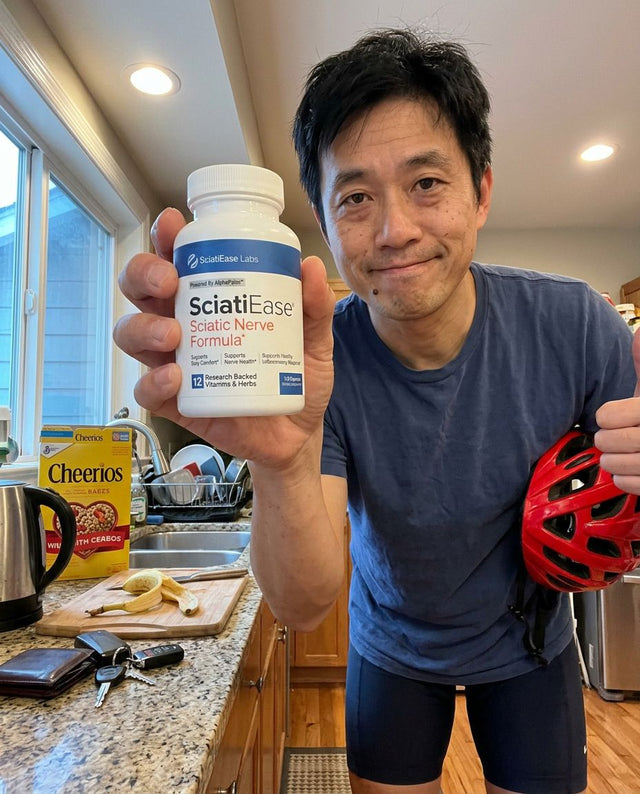 Ken T. holding a bottle of SciatiEase