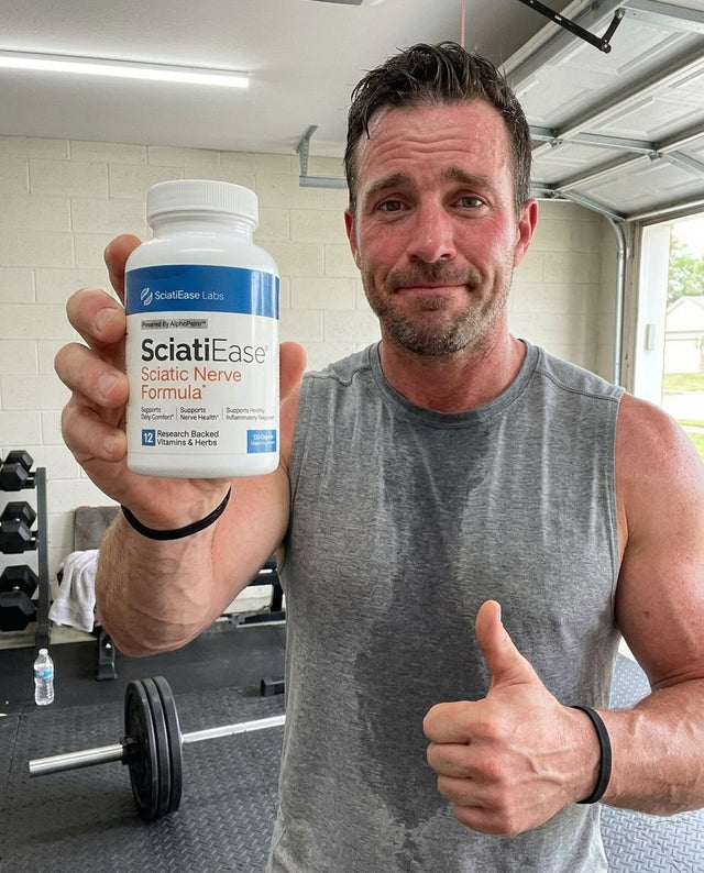 Brett A. holding a bottle of SciatiEase
