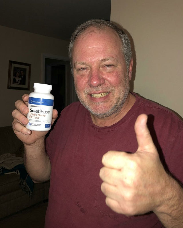 Ron K. holding a bottle of SciatiEase